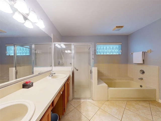 686 Middlebury Loop, New Smyrna Beach, FL 32168 - bathroom with double vanity, tile patterned flooring, a garden tub, and a stall shower