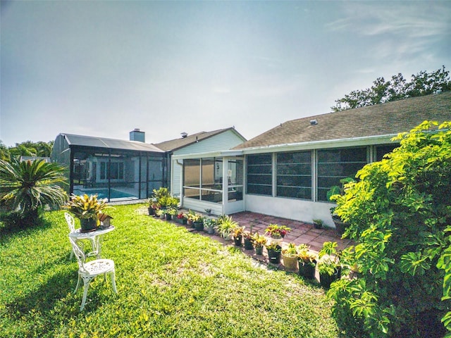 686 Middlebury Loop, New Smyrna Beach, FL 32168 - rear view of property with a yard, an outdoor pool, glass enclosure, and a sunroom