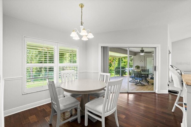 5935 Shady Creek Ln, Port Orange, FL 32128 - dining area with ceiling fan, dark wood-style flooring, and a chandelier