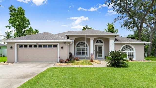5935 Shady Creek Ln, Port Orange, FL 32128 - view of front facade with an attached garage, a front yard, stucco siding, and driveway