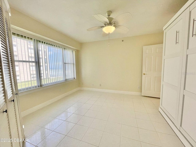 4575 S Atlantic Ave Unit 6203, Ponce Inlet, FL 32127 - empty room featuring baseboards, ceiling fan, and light tile patterned floors