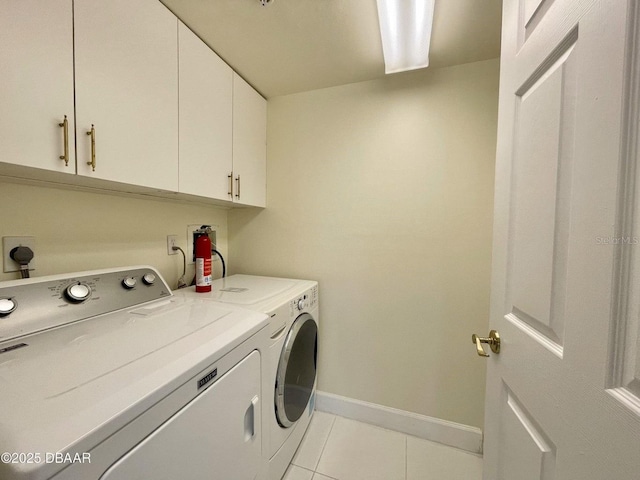 4575 S Atlantic Ave Unit 6203, Ponce Inlet, FL 32127 - laundry area featuring cabinet space, washing machine and dryer, light tile patterned floors, and baseboards