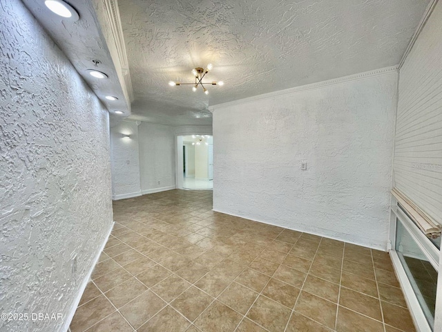 4575 S Atlantic Ave Unit 6203, Ponce Inlet, FL 32127 - unfurnished room with a textured wall, a chandelier, crown molding, tile patterned flooring, and a textured ceiling