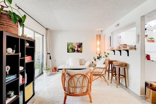 1600 Big Tree Rd Unit R4, South Daytona, FL 32119 - living area featuring a textured ceiling and light tile patterned floors