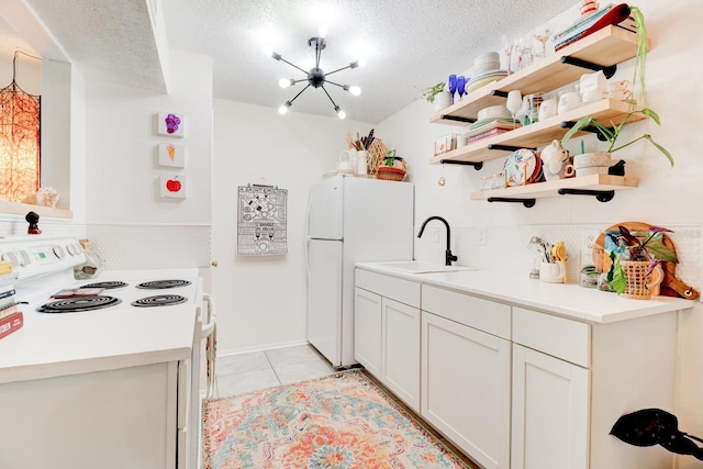 1600 Big Tree Rd Unit R4, South Daytona, FL 32119 - kitchen with white appliances, a sink, light tile patterned floors, backsplash, and open shelves