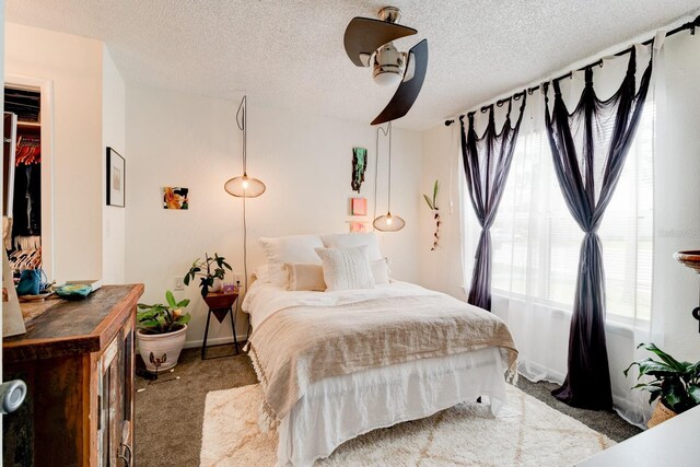 1600 Big Tree Rd Unit R4, South Daytona, FL 32119 - bedroom with carpet, a textured ceiling, baseboards, and ceiling fan