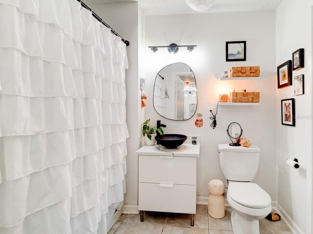 1600 Big Tree Rd Unit R4, South Daytona, FL 32119 - bathroom with vanity, toilet, baseboards, tile patterned floors, and curtained shower