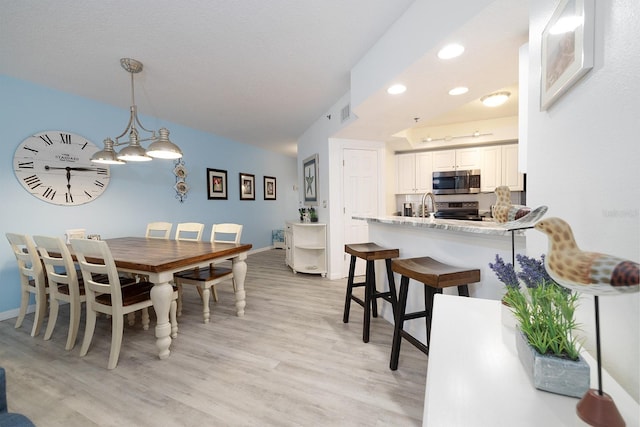 5300 S Atlantic Ave Unit 11302, New Smyrna Beach, FL 32169 - dining space with light wood-type flooring, baseboards, and recessed lighting