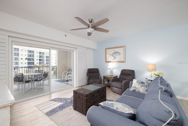 5300 S Atlantic Ave Unit 11302, New Smyrna Beach, FL 32169 - living area featuring a ceiling fan, light wood-style floors, and a textured ceiling
