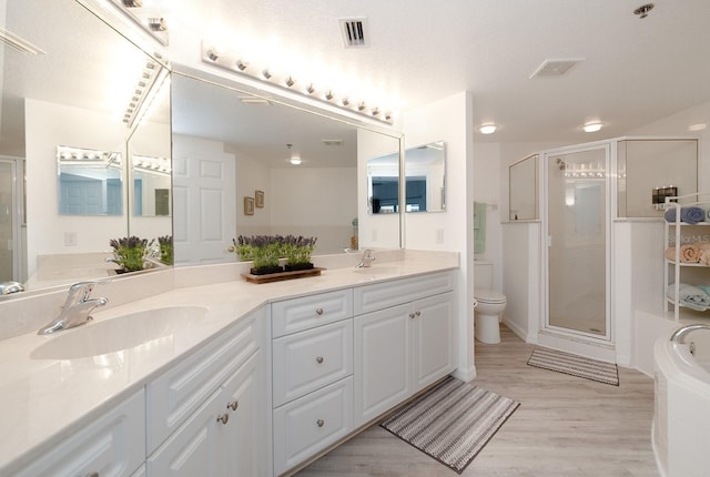 5300 S Atlantic Ave Unit 11302, New Smyrna Beach, FL 32169 - full bath with double vanity, a stall shower, wood finished floors, toilet, and a bath