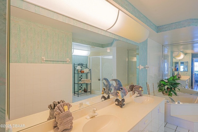 4555 S Atlantic Ave Unit 4405, Ponce Inlet, FL 32127 - bathroom featuring a shower stall, a garden tub, double vanity, and tile walls