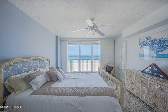 4555 S Atlantic Ave Unit 4405, Ponce Inlet, FL 32127 - bedroom featuring access to exterior, a textured ceiling, a ceiling fan, a water view, and baseboards