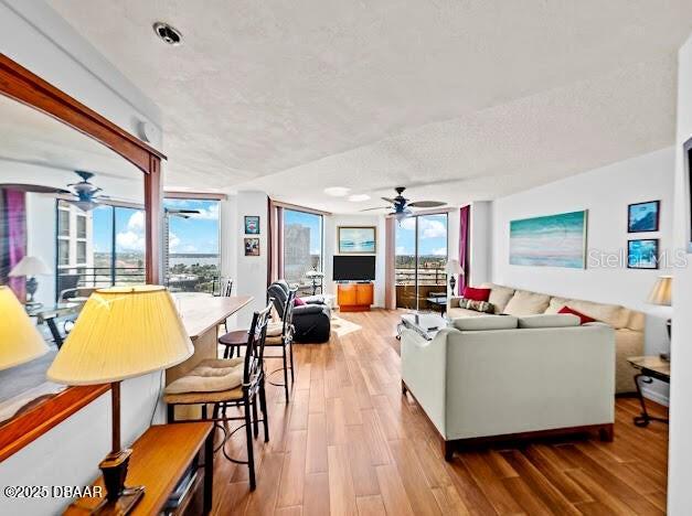 3023 S Atlantic Ave Unit 8010, Daytona Beach, FL 32118 - living room featuring a ceiling fan, wood finished floors, and a textured ceiling