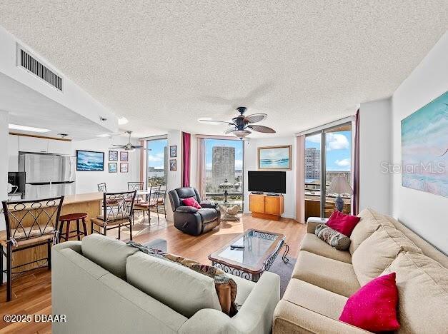 3023 S Atlantic Ave Unit 8010, Daytona Beach, FL 32118 - living area featuring ceiling fan, a textured ceiling, and light wood-style flooring