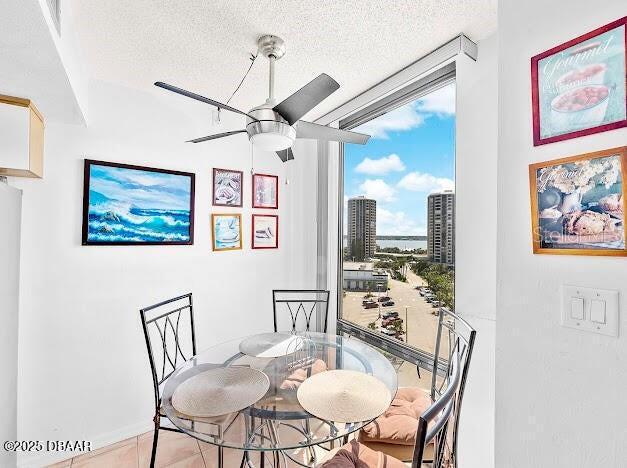 3023 S Atlantic Ave Unit 8010, Daytona Beach, FL 32118 - dining room with a ceiling fan, expansive windows, a textured ceiling, and a view of city
