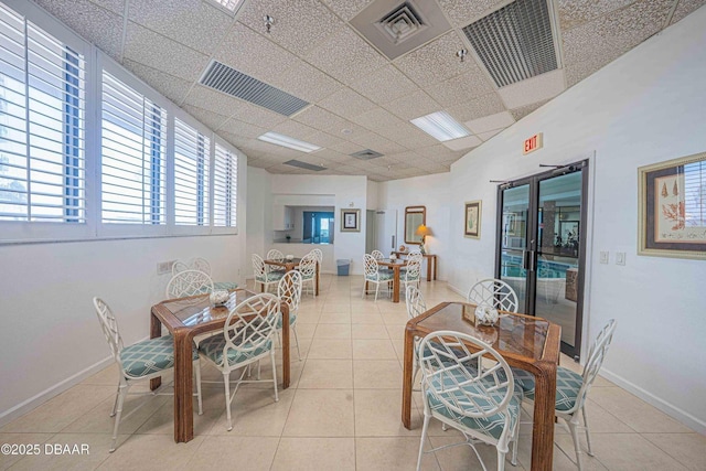 3023 S Atlantic Ave Unit 8010, Daytona Beach, FL 32118 - dining room with tile patterned floors, a paneled ceiling, and baseboards