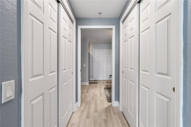 2 Oceans W Blvd Unit 608, Daytona Beach Shores, FL 32118 - hall featuring light wood-style flooring, baseboards, and a textured wall