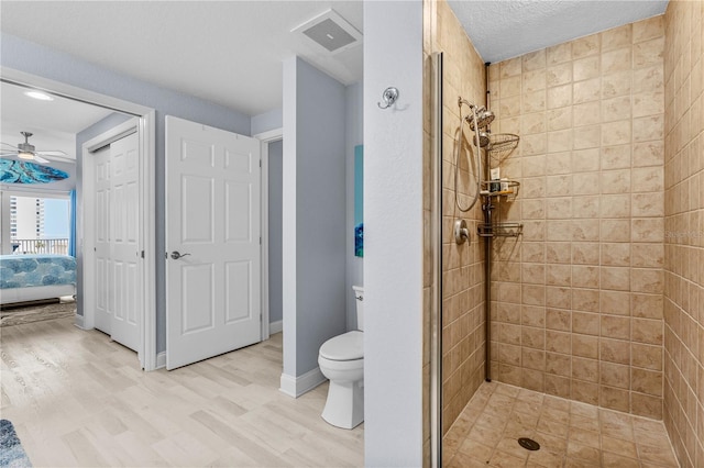 2 Oceans W Blvd Unit 608, Daytona Beach Shores, FL 32118 - full bathroom with a stall shower, toilet, wood finished floors, ensuite bath, and a ceiling fan