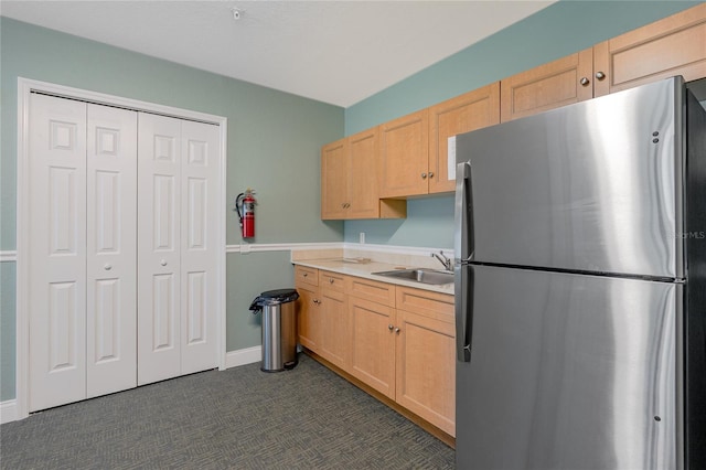 2 Oceans W Blvd Unit 608, Daytona Beach Shores, FL 32118 - kitchen with freestanding refrigerator, a sink, light brown cabinetry, dark colored carpet, and light countertops