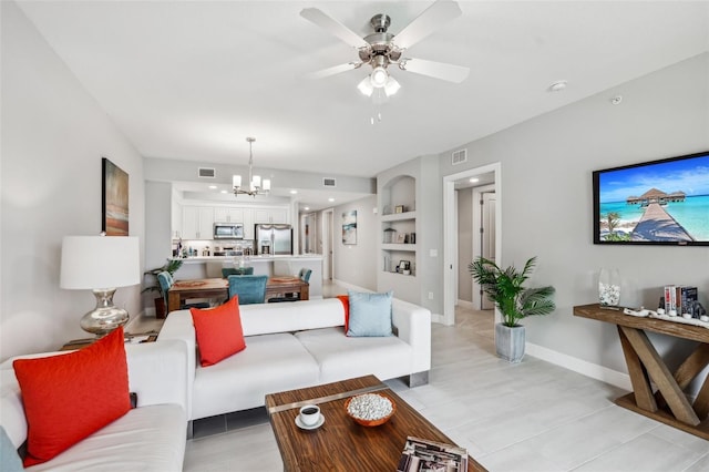 7 Riverwalk Dr Unit 305, New Smyrna Beach, FL 32169 - living area with a chandelier, a ceiling fan, built in features, and baseboards