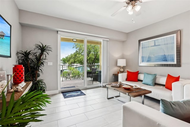 7 Riverwalk Dr Unit 305, New Smyrna Beach, FL 32169 - living area with baseboards, ceiling fan, and light tile patterned flooring