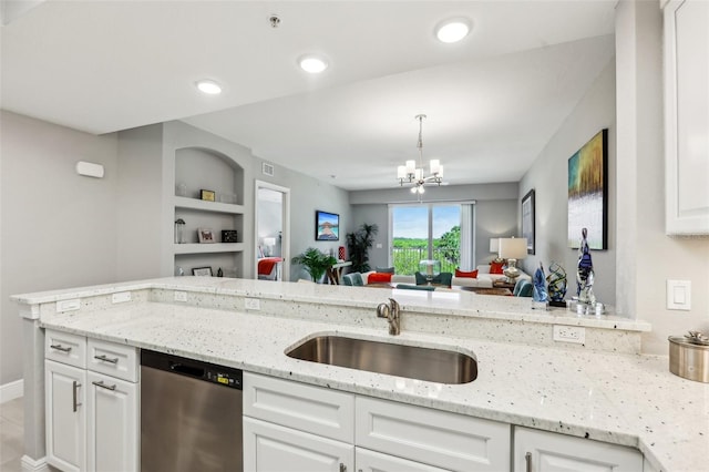 7 Riverwalk Dr Unit 305, New Smyrna Beach, FL 32169 - kitchen featuring stainless steel dishwasher, a sink, a chandelier, white cabinets, and recessed lighting