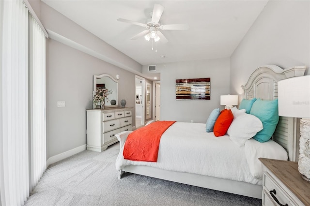 7 Riverwalk Dr Unit 305, New Smyrna Beach, FL 32169 - bedroom with light carpet, ensuite bath, baseboards, and a ceiling fan