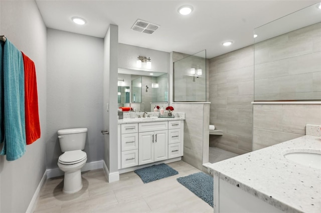 7 Riverwalk Dr Unit 305, New Smyrna Beach, FL 32169 - bathroom featuring vanity, walk in shower, toilet, and baseboards