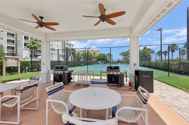7 Riverwalk Dr Unit 305, New Smyrna Beach, FL 32169 - view of patio / terrace with a tennis court, a grill, and ceiling fan