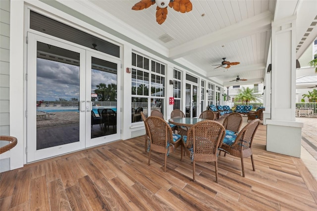 7 Riverwalk Dr Unit 305, New Smyrna Beach, FL 32169 - sunroom / solarium with french doors, a ceiling fan, beam ceiling, and outdoor dining space