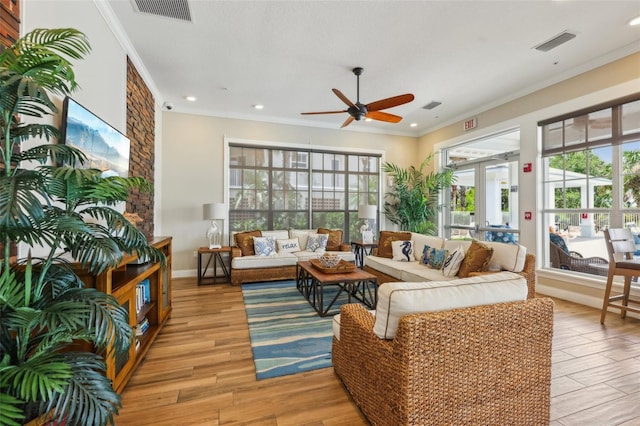 7 Riverwalk Dr Unit 305, New Smyrna Beach, FL 32169 - living area with a ceiling fan, ornamental molding, healthy amount of natural light, light wood-type flooring, and baseboards