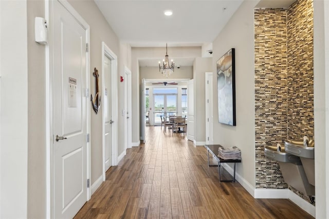 7 Riverwalk Dr Unit 305, New Smyrna Beach, FL 32169 - hallway with a chandelier, dark wood finished floors, baseboards, and recessed lighting