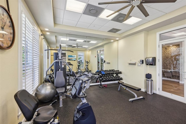 7 Riverwalk Dr Unit 305, New Smyrna Beach, FL 32169 - gym featuring a ceiling fan, a paneled ceiling, and baseboards