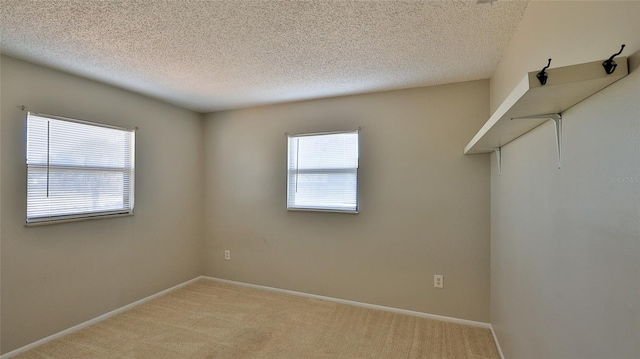 1802 N Fern Palm Dr, Edgewater, FL 32132 - spare room with light colored carpet, a textured ceiling, and baseboards
