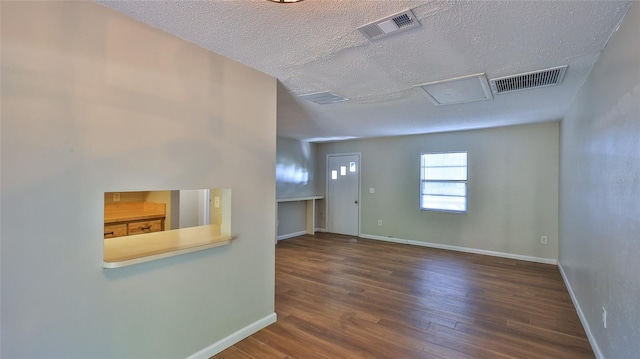 1802 N Fern Palm Dr, Edgewater, FL 32132 - empty room featuring a textured ceiling, wood finished floors, baseboards, and attic access