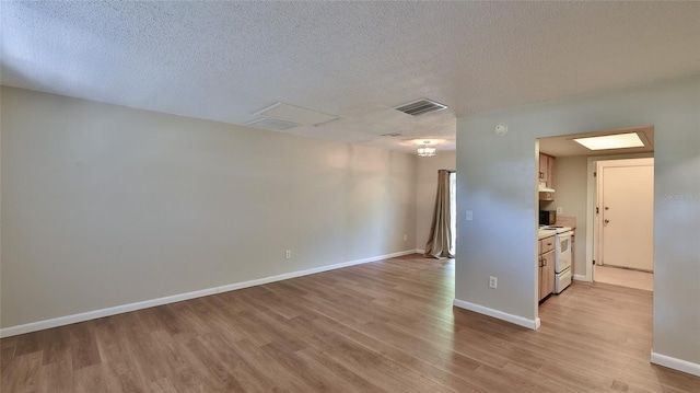 1802 N Fern Palm Dr, Edgewater, FL 32132 - empty room with light wood-style flooring, a textured ceiling, and baseboards