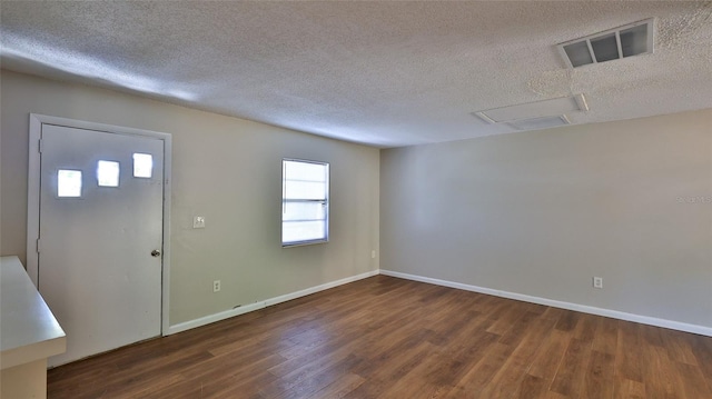 1802 N Fern Palm Dr, Edgewater, FL 32132 - foyer entrance with a textured ceiling, wood finished floors, and baseboards