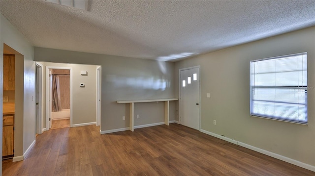 1802 N Fern Palm Dr, Edgewater, FL 32132 - foyer entrance featuring a textured ceiling, wood finished floors, plenty of natural light, and baseboards
