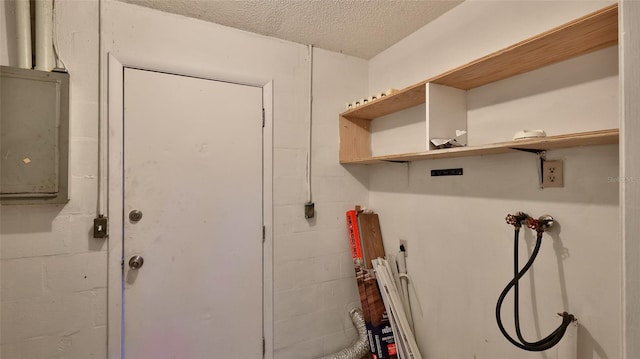 1802 N Fern Palm Dr, Edgewater, FL 32132 - washroom featuring concrete block wall, hookup for a washing machine, a textured ceiling, and electric panel