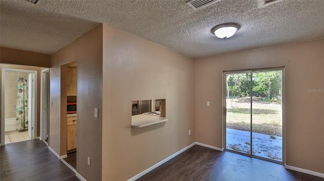 1802 N Fern Palm Dr, Edgewater, FL 32132 - doorway with wood finished floors, a textured ceiling, and baseboards