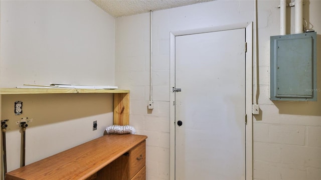 1802 N Fern Palm Dr, Edgewater, FL 32132 - interior space featuring hookup for an electric dryer, concrete block wall, electric panel, and a textured ceiling