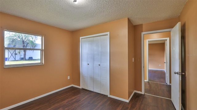 1802 N Fern Palm Dr, Edgewater, FL 32132 - unfurnished bedroom with dark wood-style floors, a closet, baseboards, and a textured ceiling