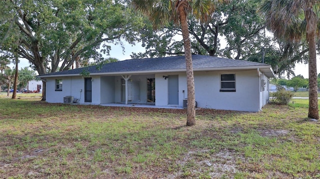 1802 N Fern Palm Dr, Edgewater, FL 32132 - back of property featuring stucco siding, a lawn, and a patio