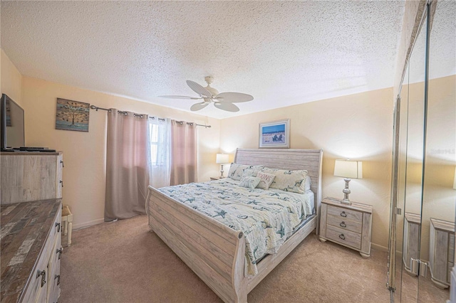3615 S Atlantic Ave Unit 211, Daytona Beach, FL 32118 - bedroom featuring light carpet, a textured ceiling, ceiling fan, and baseboards