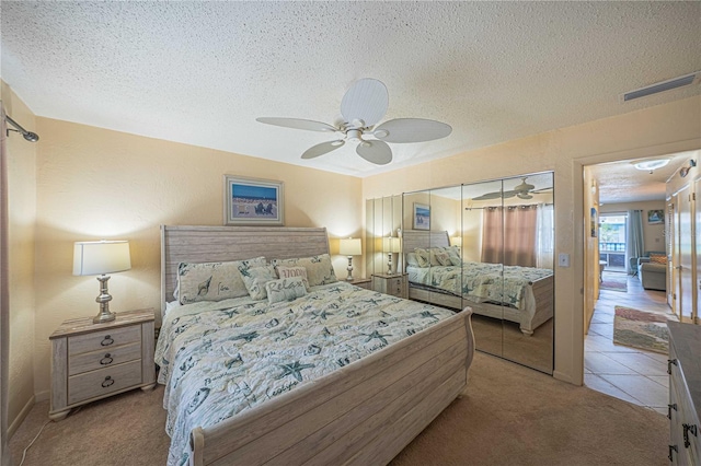 3615 S Atlantic Ave Unit 211, Daytona Beach, FL 32118 - carpeted bedroom with a textured ceiling, a ceiling fan, and a closet
