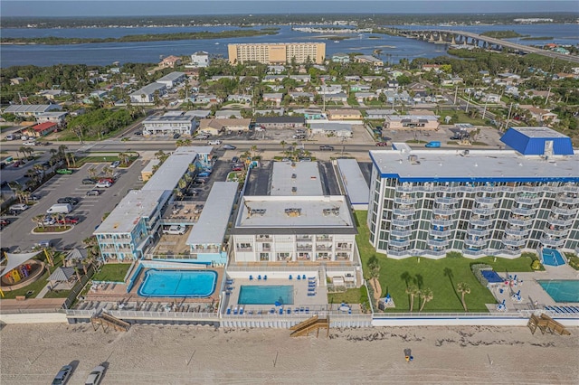 3615 S Atlantic Ave Unit 211, Daytona Beach, FL 32118 - drone / aerial view of a pool, a large body of water, and a notable bridge