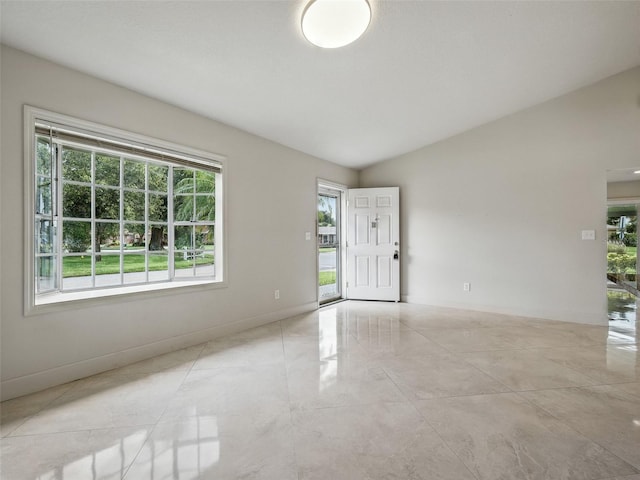 2 Birdie Dr, New Smyrna Beach, FL 32168 - spare room with lofted ceiling and baseboards