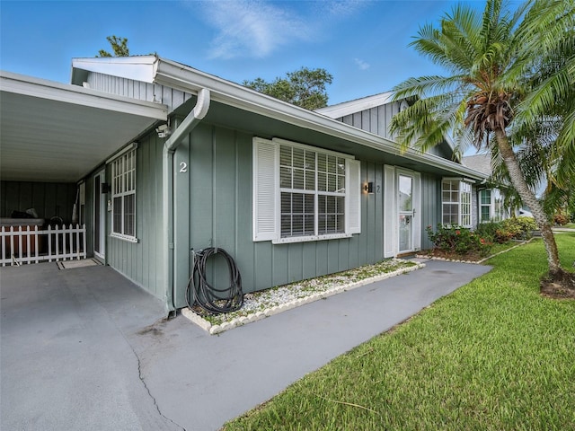 2 Birdie Dr, New Smyrna Beach, FL 32168 - view of home's exterior with a yard