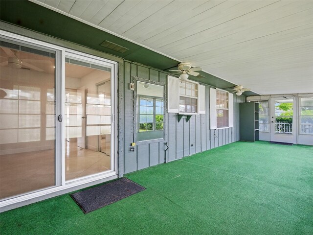 2 Birdie Dr, New Smyrna Beach, FL 32168 - unfurnished sunroom with plenty of natural light and ceiling fan