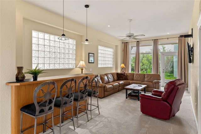 6956 Turtlemound Rd, New Smyrna Beach, FL 32169 - living area featuring a dry bar, light colored carpet, and a ceiling fan
